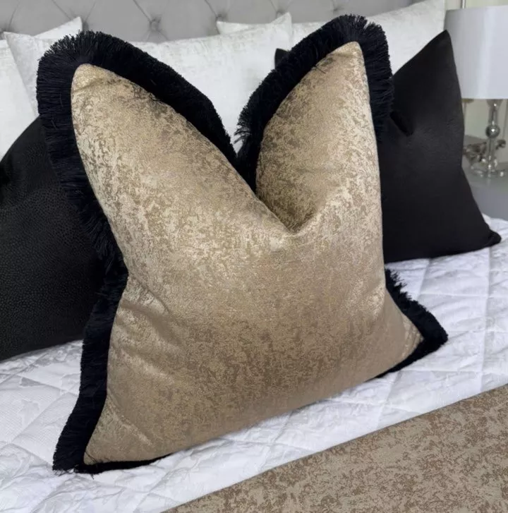Brass fringed feather filled cushion
